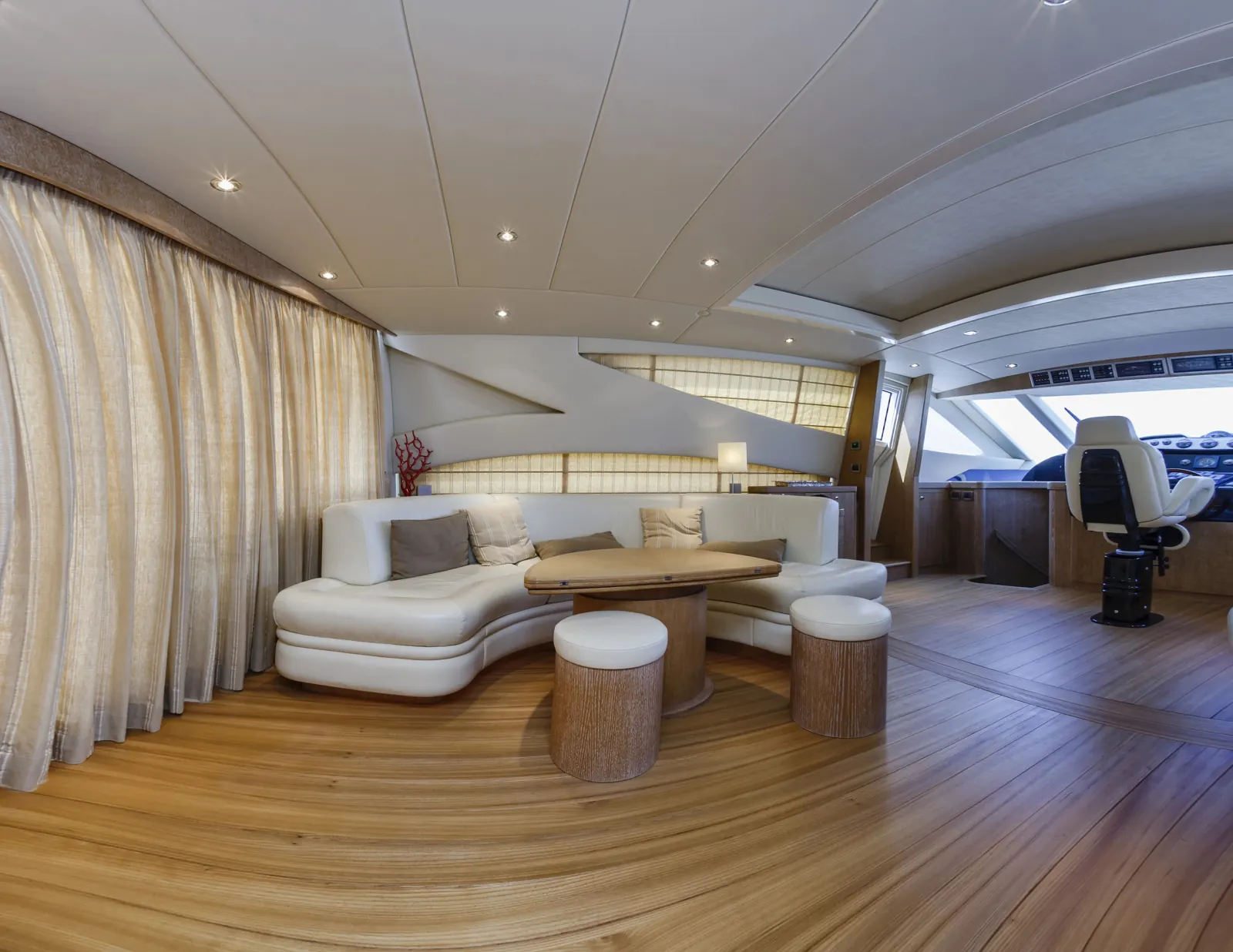 Yacht salon with wood flooring and curved seating