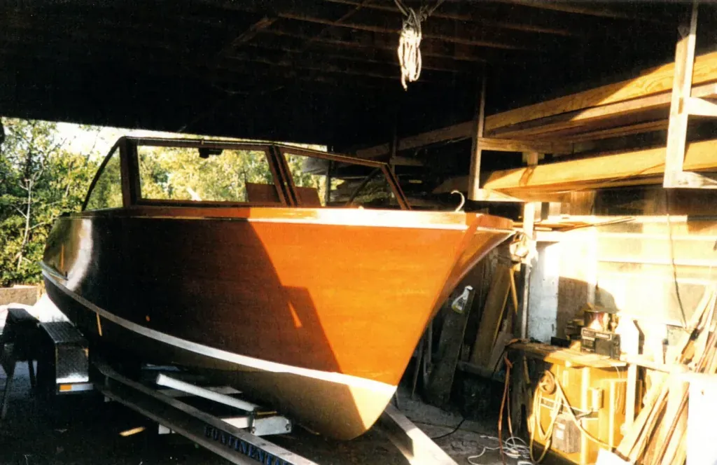 Restored Chris Craft with varnished mahogany topsides in the shop