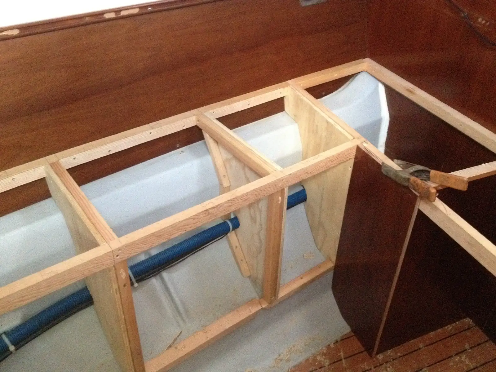 Interior refit in progress with new plywood partition and cabinet framing